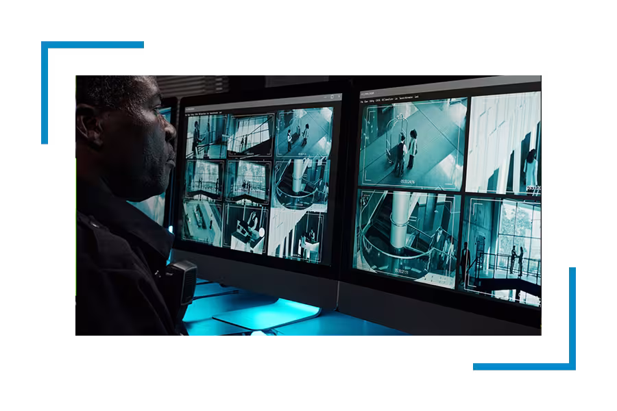 Security professional monitoring screens